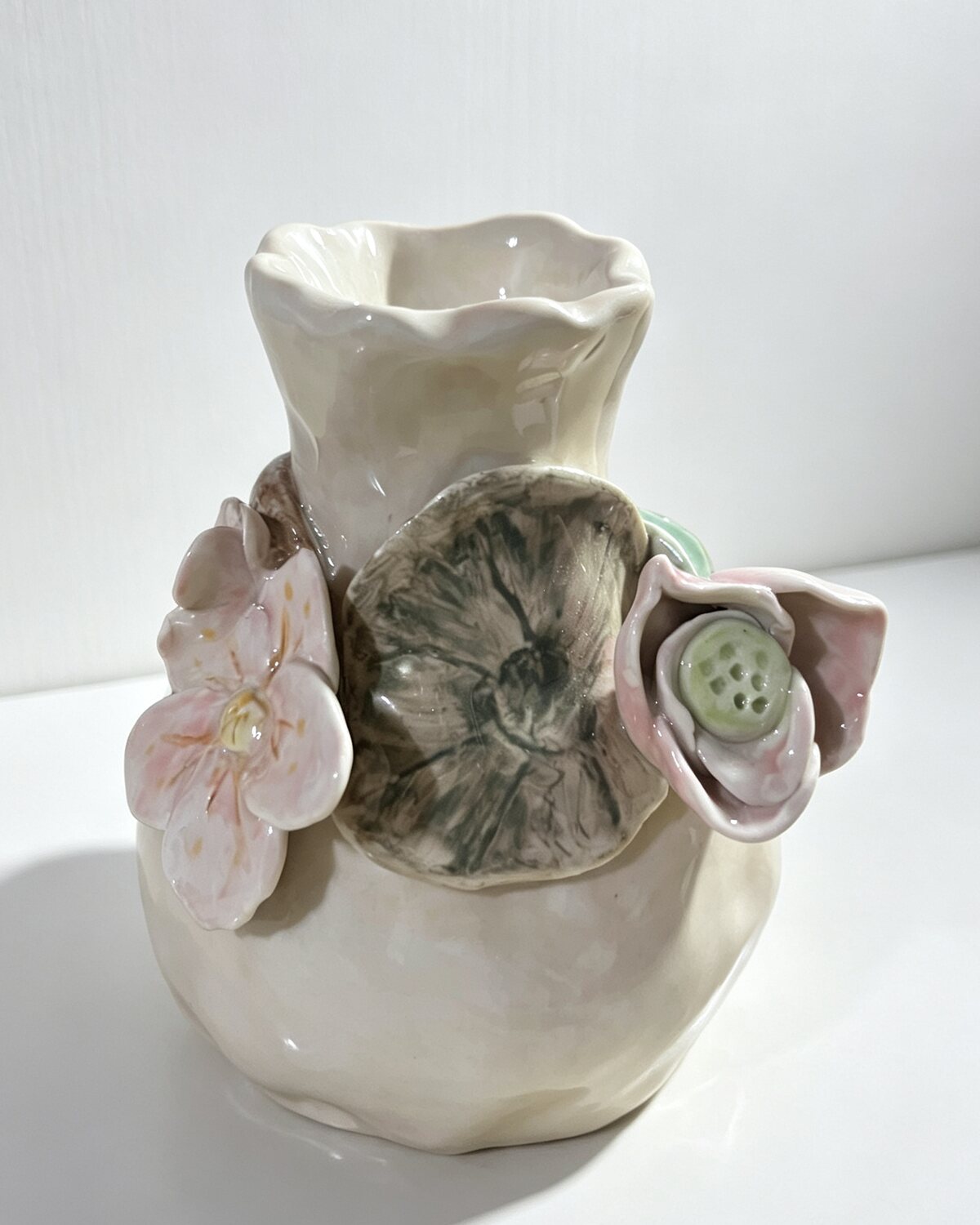 A hand-built ceramic vase photographed on the studio table