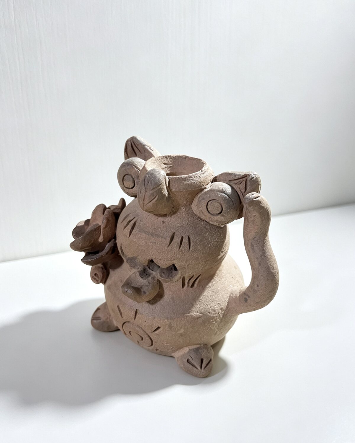 Hand-carved unglazed Wama cat mini flower vase