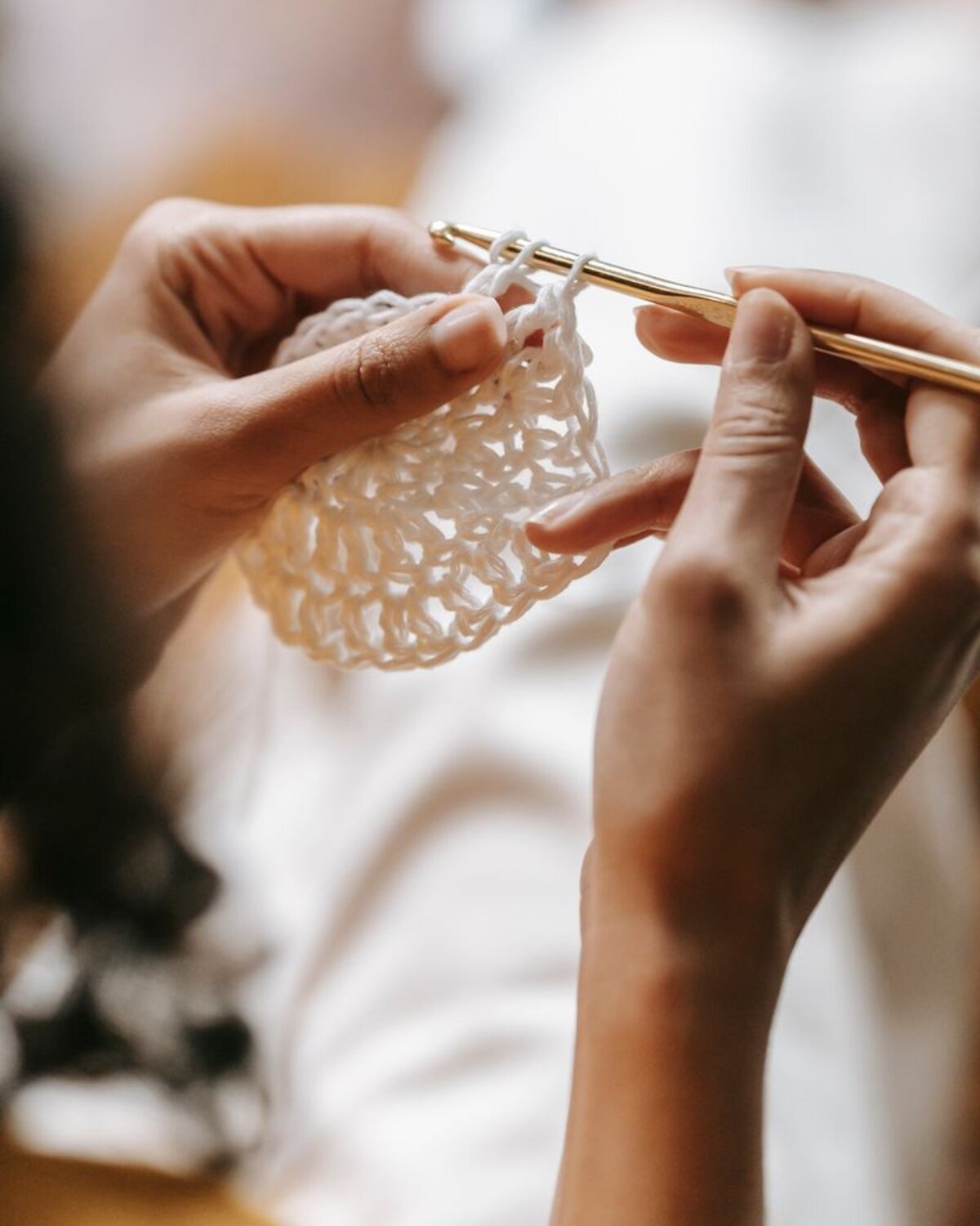 Temporary reference photo of a light openwork crochet piece being made
